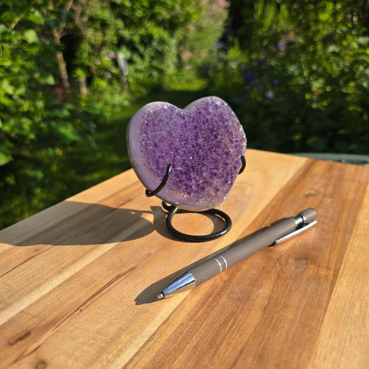 Amethyst Druse Amethyst Geode in Herzform mit Metallsockel 10x9x7cm - NR-55 auf Holzuntergrund mit Stift daneben