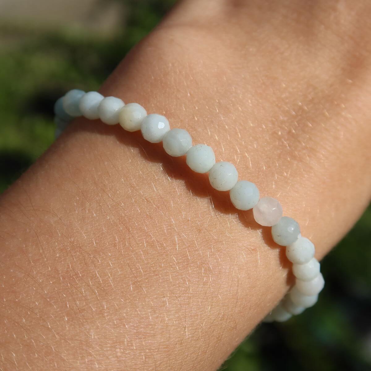 Faceted Amazonite gemstone bracelet on wrist, showcasing serene blue-green beads in a modern design.