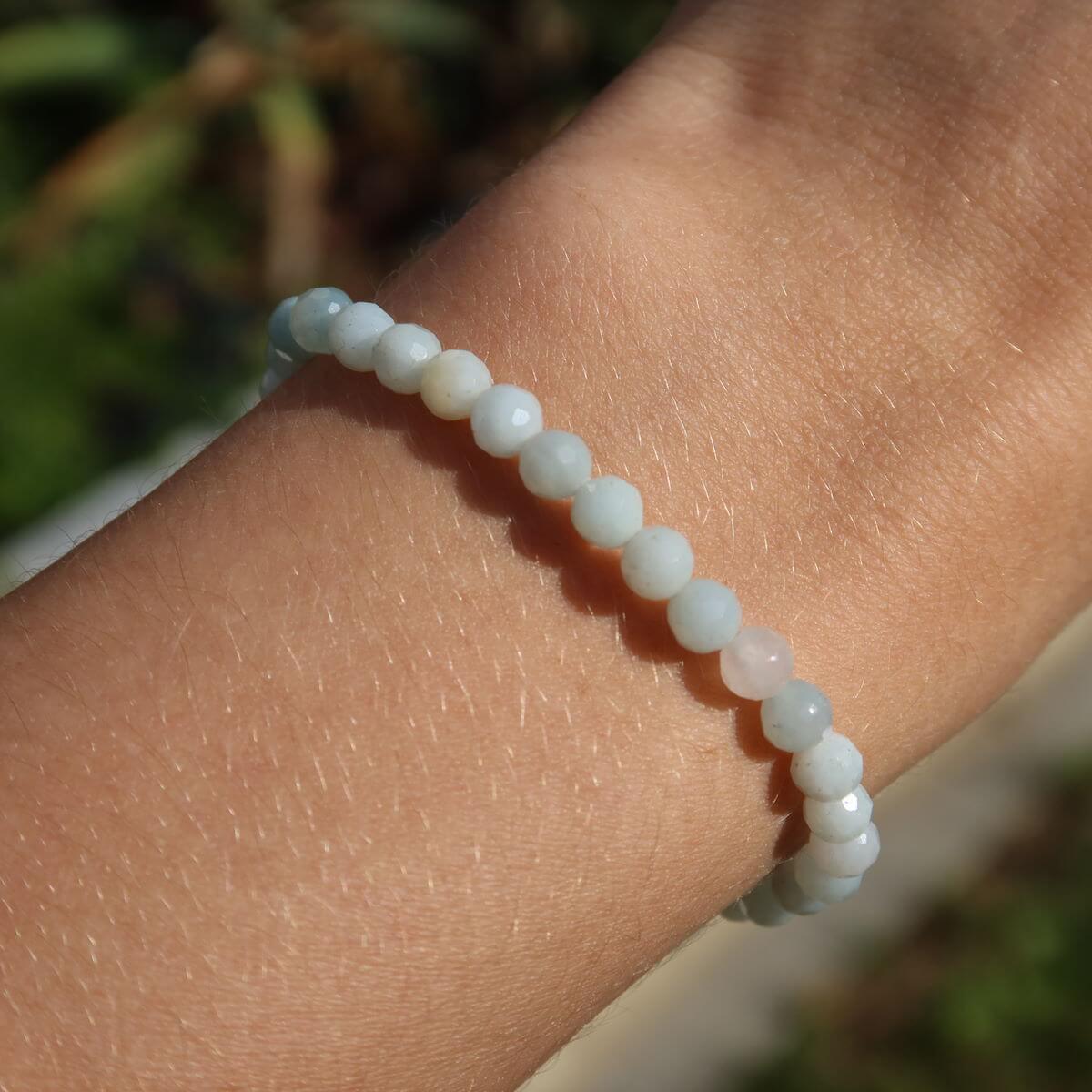Faceted Amazonite gemstone bracelet on wrist, showcasing serene blue-green beads in a modern design.