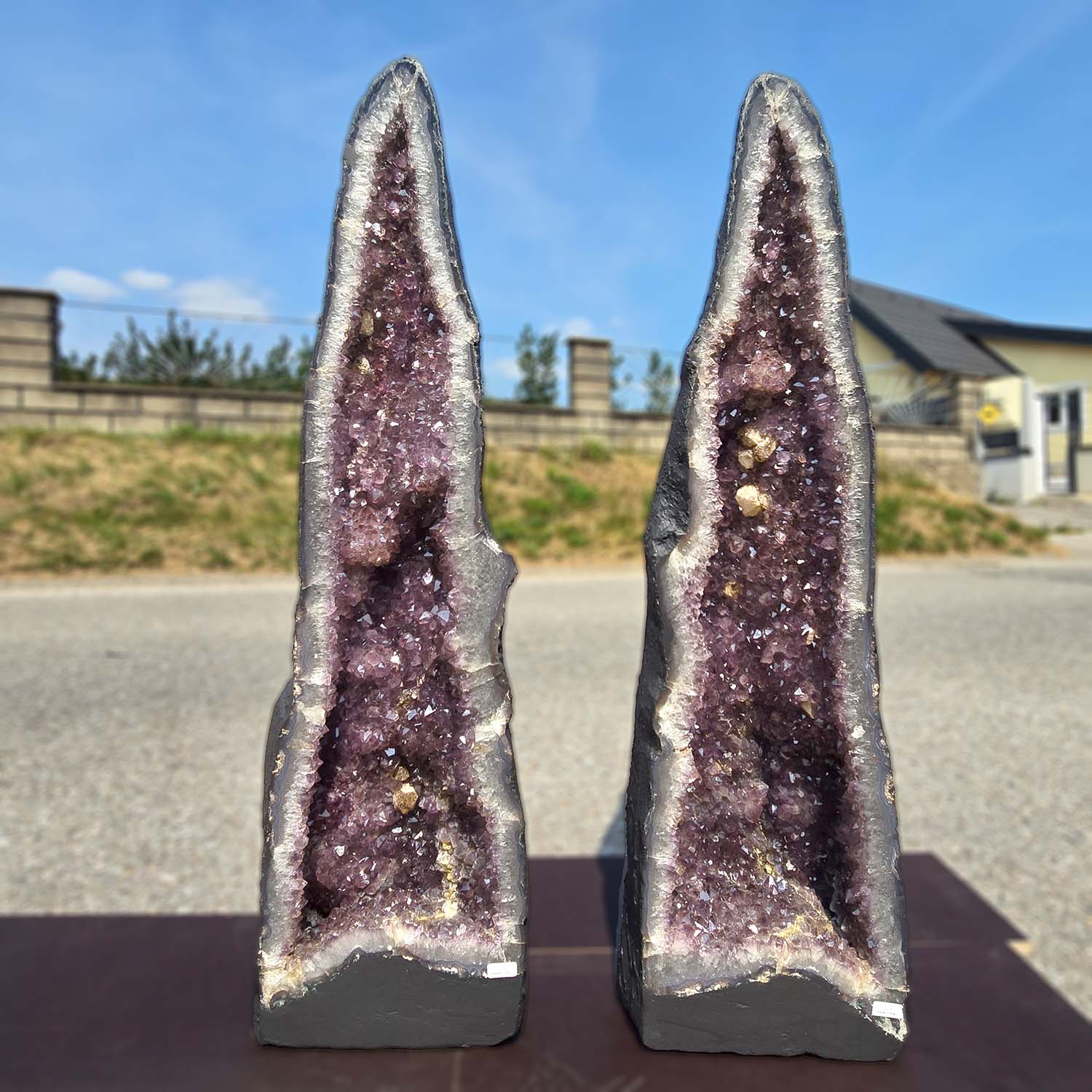 Pair of Amethyst Geode Crystals promoting harmony and relaxation, displayed outdoors on a sunny day