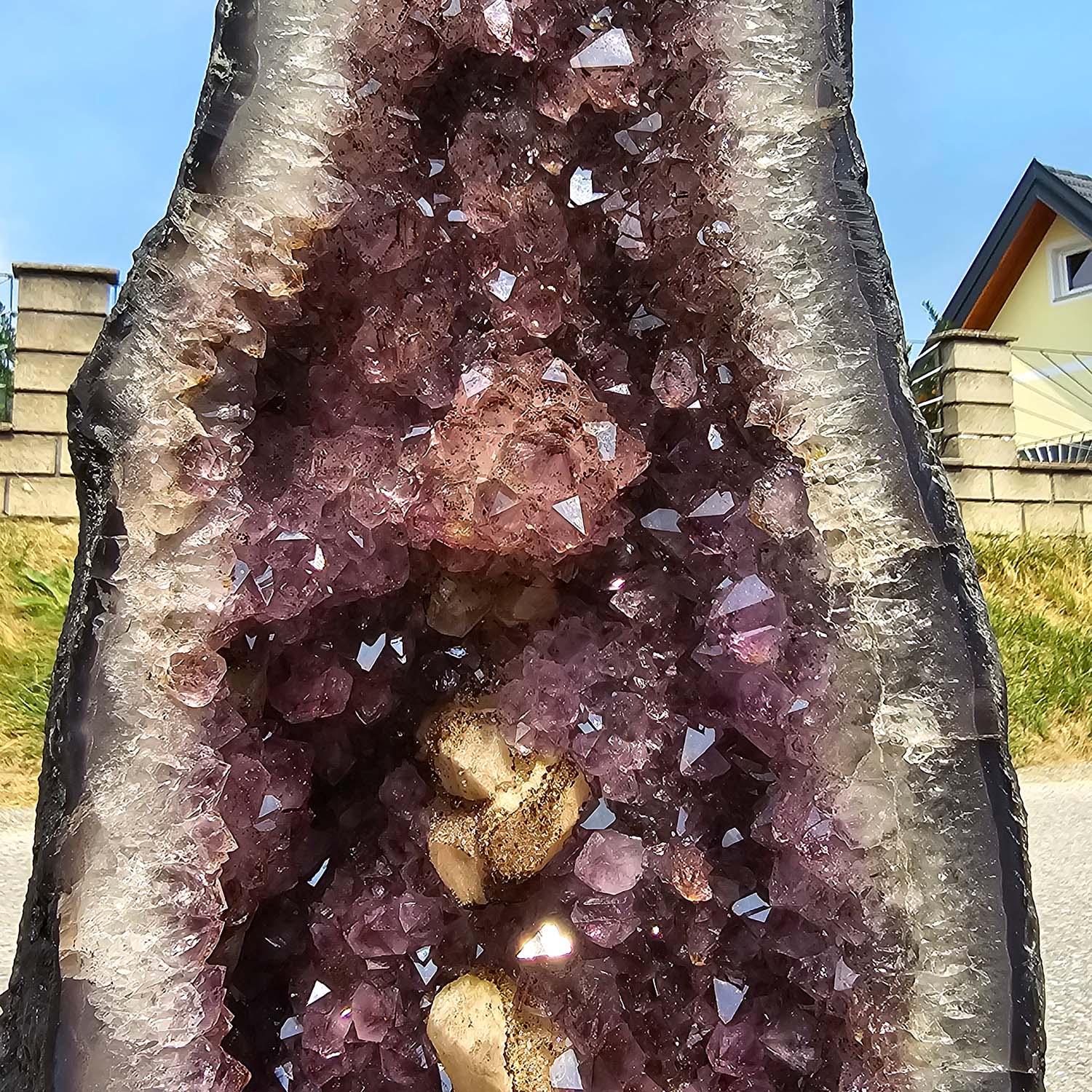 Pair of Amethyst Geode Crystals promoting harmony and relaxation, displayed outdoors on a sunny day