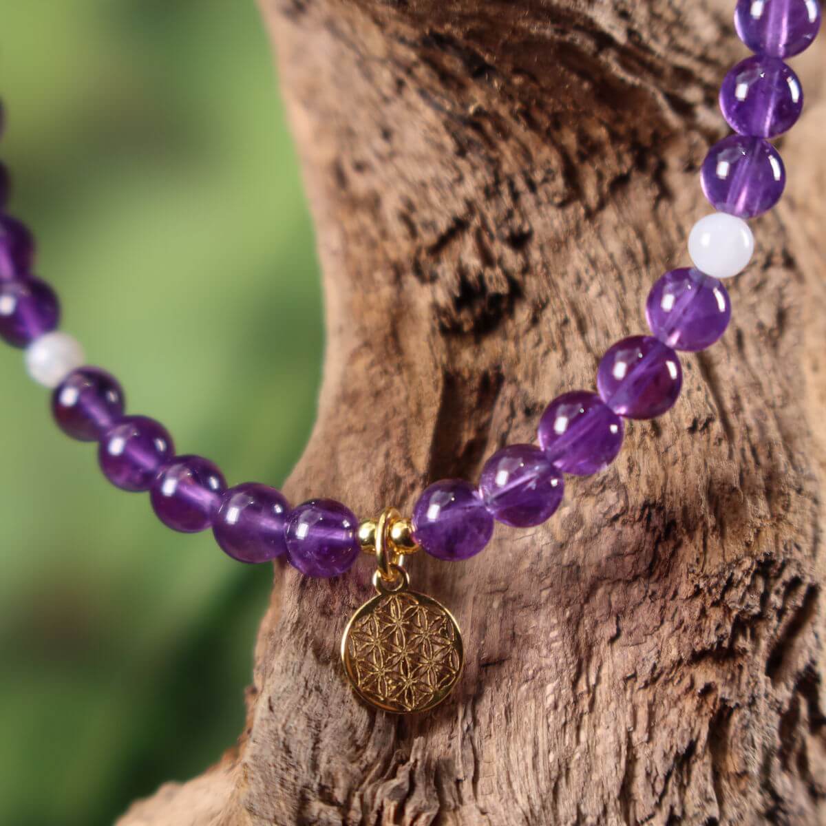 Amethyst and white labradorite necklace with Flower of Life pendant on a wooden stand, 41cm, symbolizes spirituality and femininity.