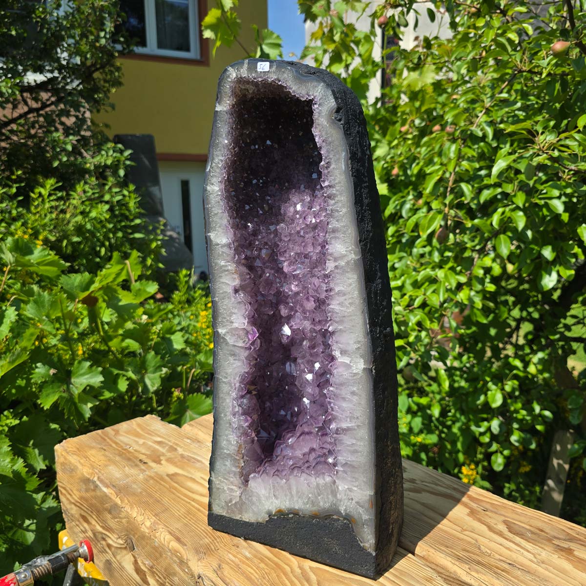 Amethyst Druse – Geode - 54x22x22cm und 27kg – Steinwelten OG - Nr. 56 in natural sunlight on wooden surface