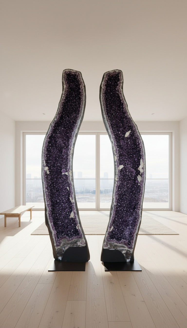 AA-quality large amethyst geode pair with deep violet crystals displayed in a garage setting