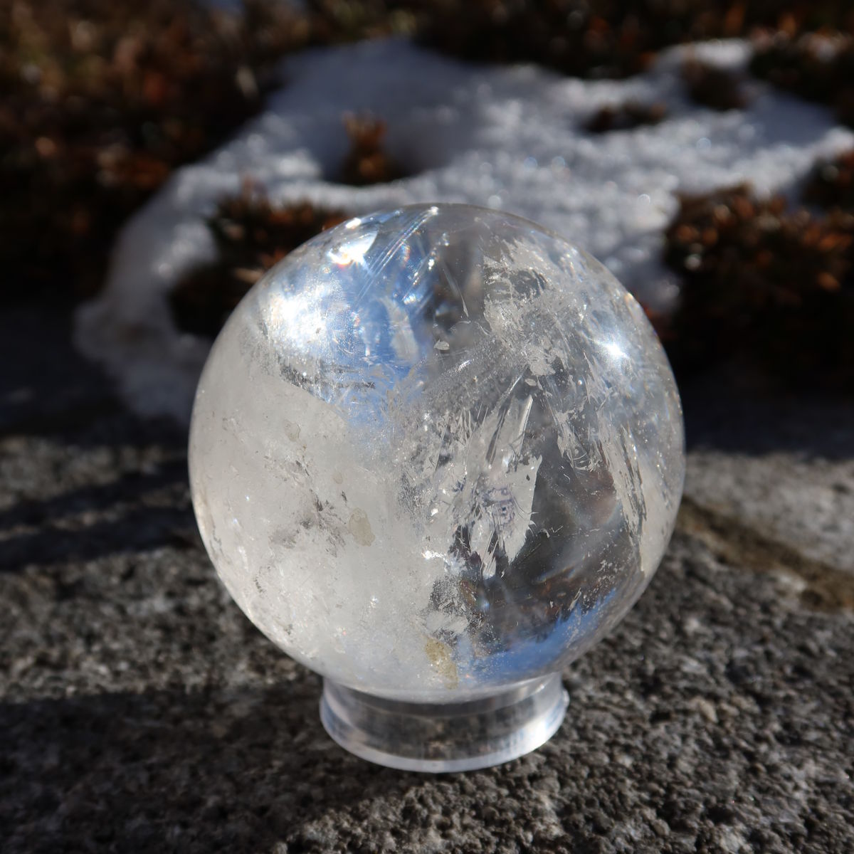 Bergkristall Kugel – Natürliche Kristallkugel 60mm Durchmesser Nr. 38 auf Felsen Hintergrund