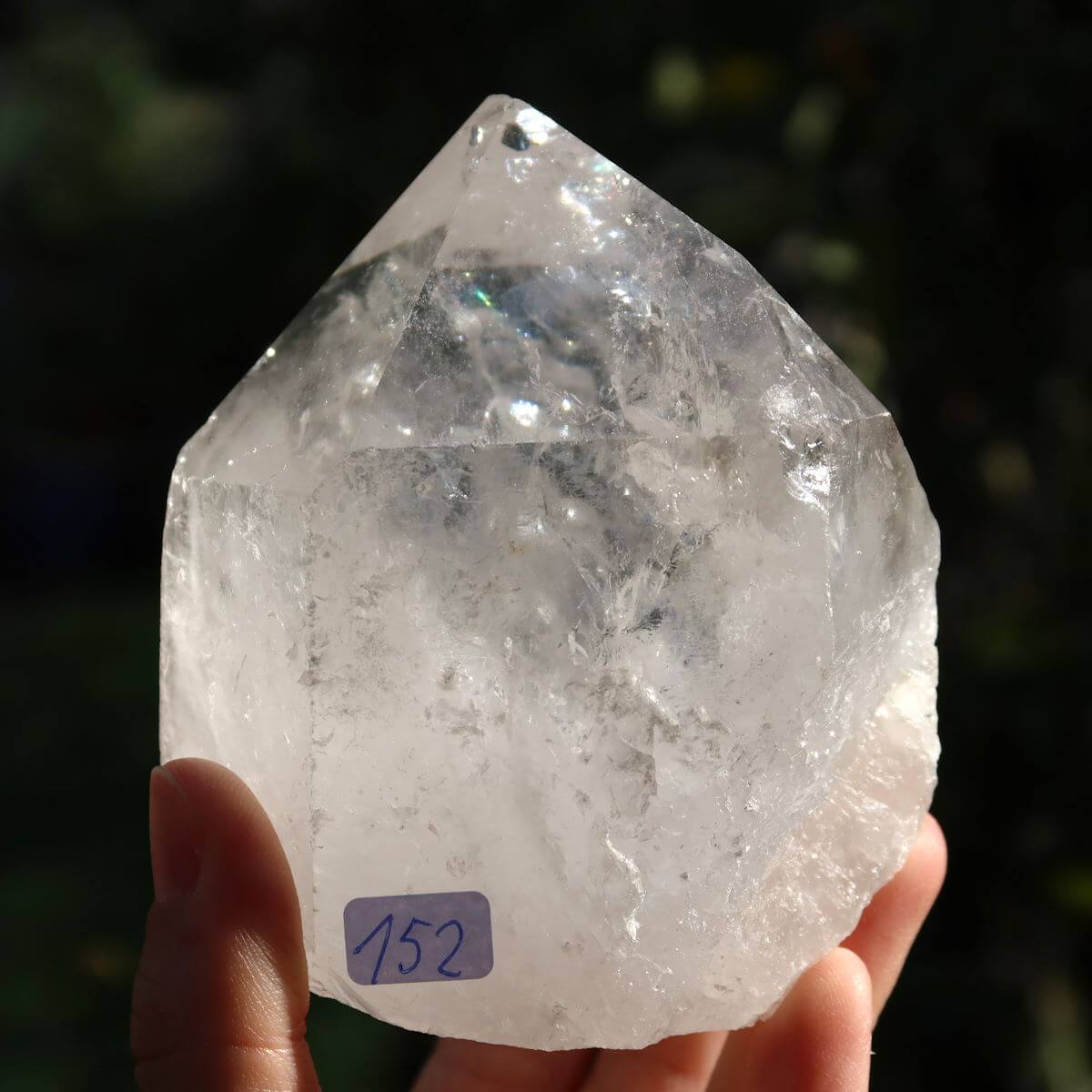 Clear quartz crystal point, hand-held, with unique faceted surfaces for meditation, size 8x7 cm, Brazil origin, product no. 152.