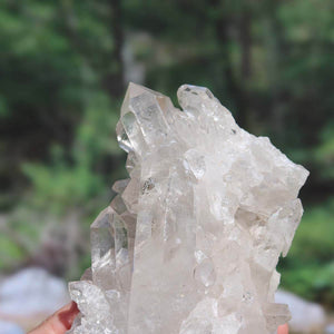 Raw Brazilian bergkristall crystal cluster, 1.36kg, showcasing natural clarity and unique growth formations.