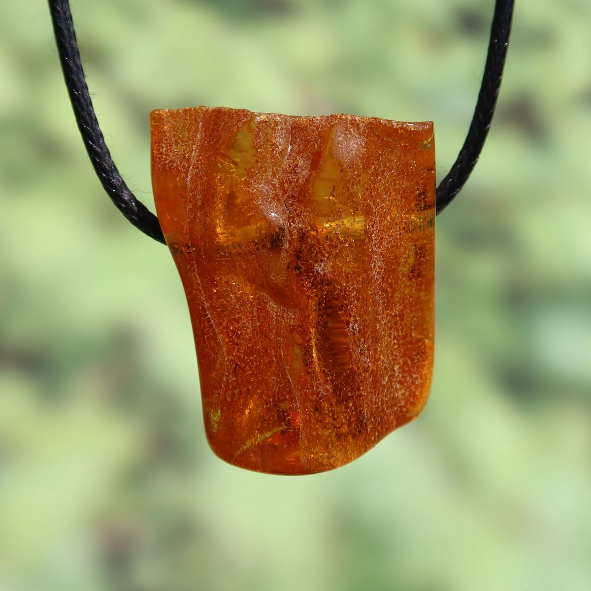 Naturally polished 35mm amber pendant displaying vibrant clarity, enhancing joy and confidence. Unique piece number 17.