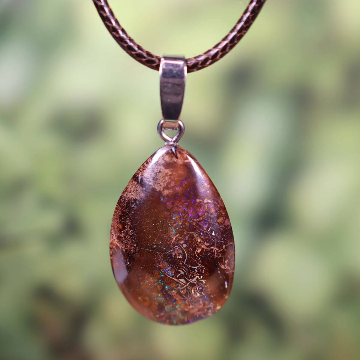 Handcrafted Boulder Opal pendant with rhodium-plated silver loop, 32x20mm, unique gemstone from Australia.