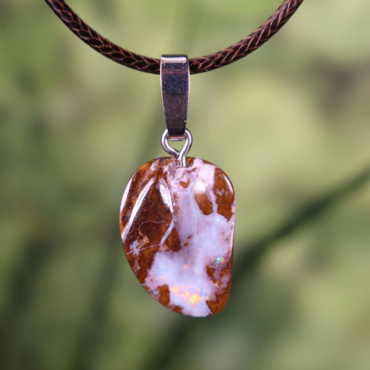 Handcrafted Boulder Opal pendant with rhodium-plated silver bail on leather cord, unique natural gemstone jewelry.