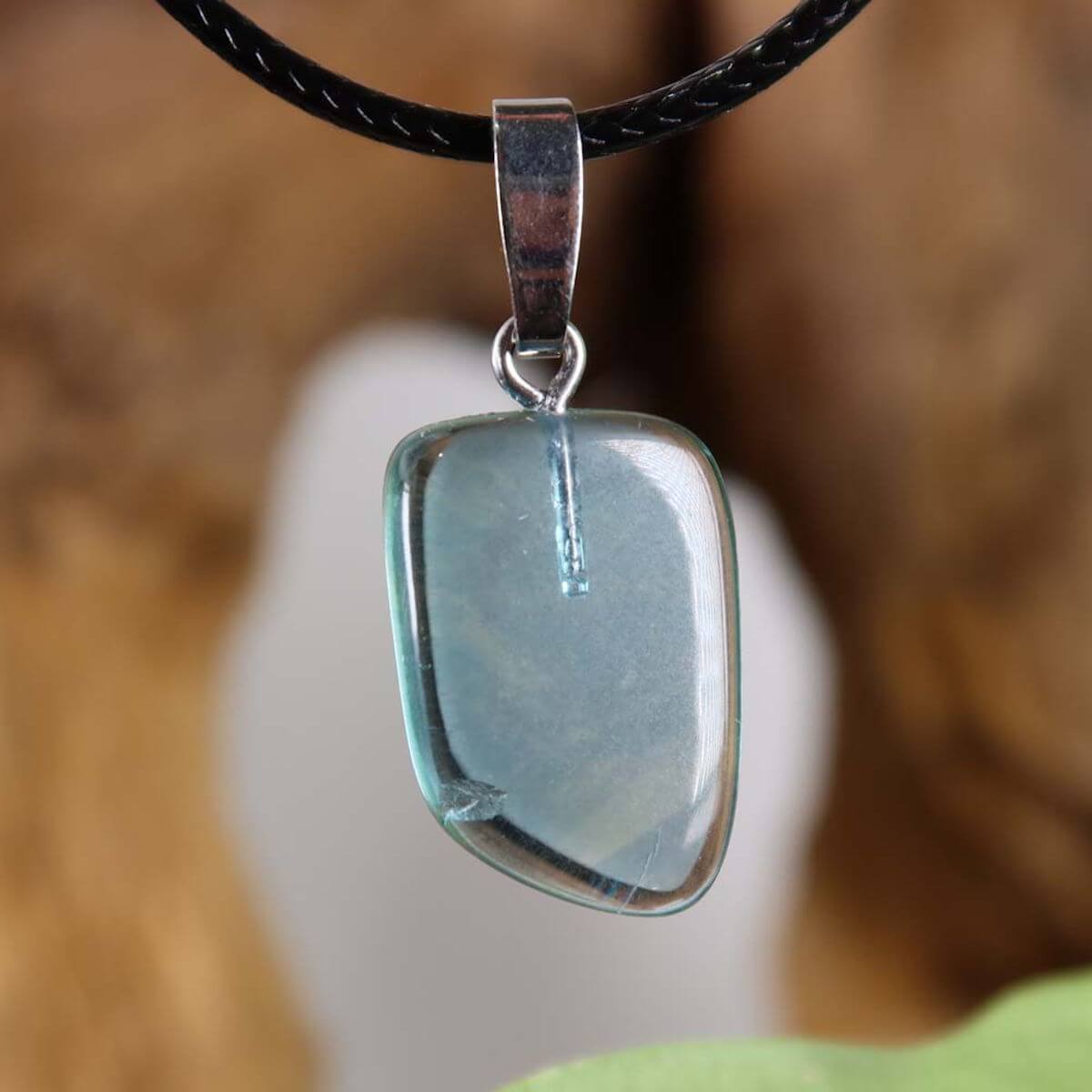 Fluorite pendant with silver rhodium-plated clasp, unique design showcasing pale blue shade, ideal for concentration and renewal.