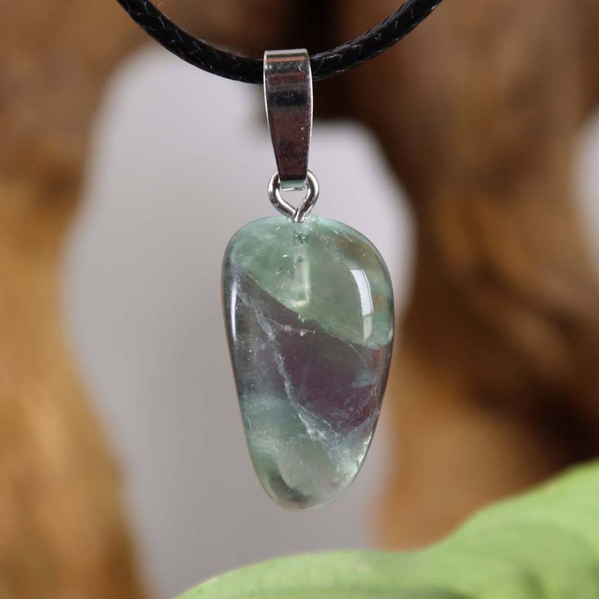 Fluorite gemstone pendant with silver rhodium-plated bail, showcasing unique green and purple hues. Unikat Nr. 19, enhancing concentration and freedom.