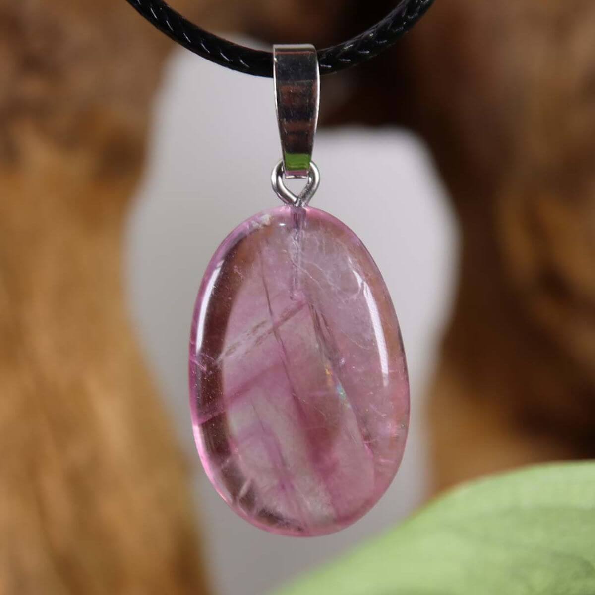 Pink Fluorit gemstone pendant with silver rhodium-plated loop, showcasing unique patterns and coloration.