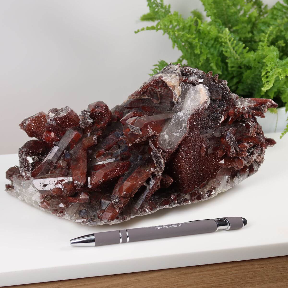 Seltene Hämatit Quarz Bergkristall Stufe aus Marokko, Eisenquarz mit intensiven Farben, neben Kugelschreiber zur Größendarstellung.