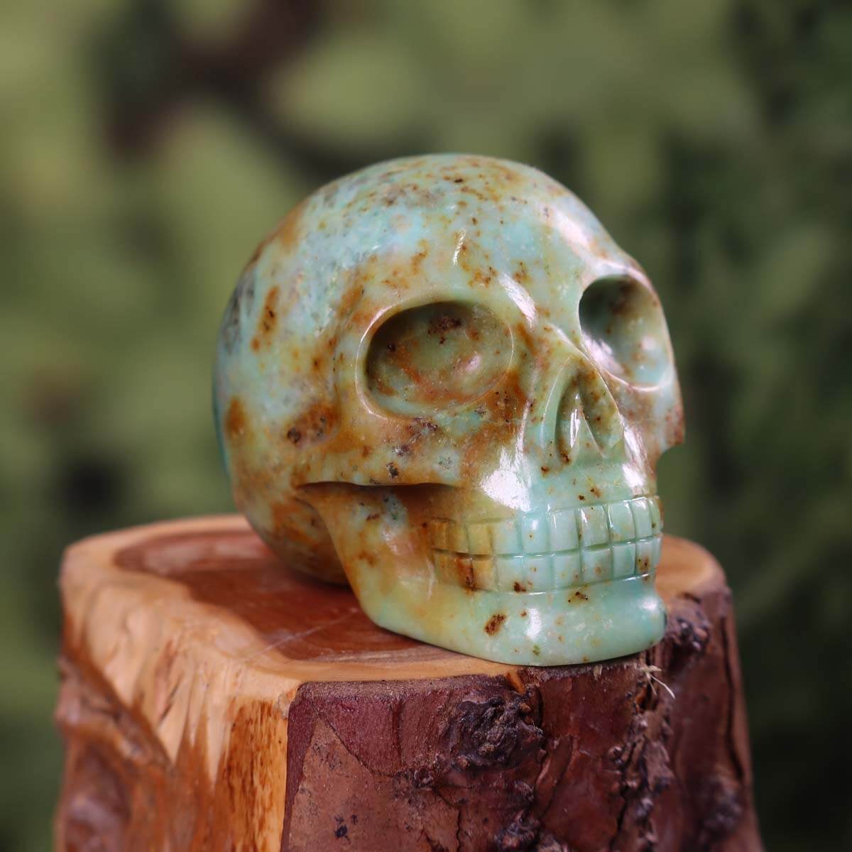 Handcrafted Andenopal crystal skull on wooden base, 6x6 cm, showcasing unique patterns and vibrant colors.