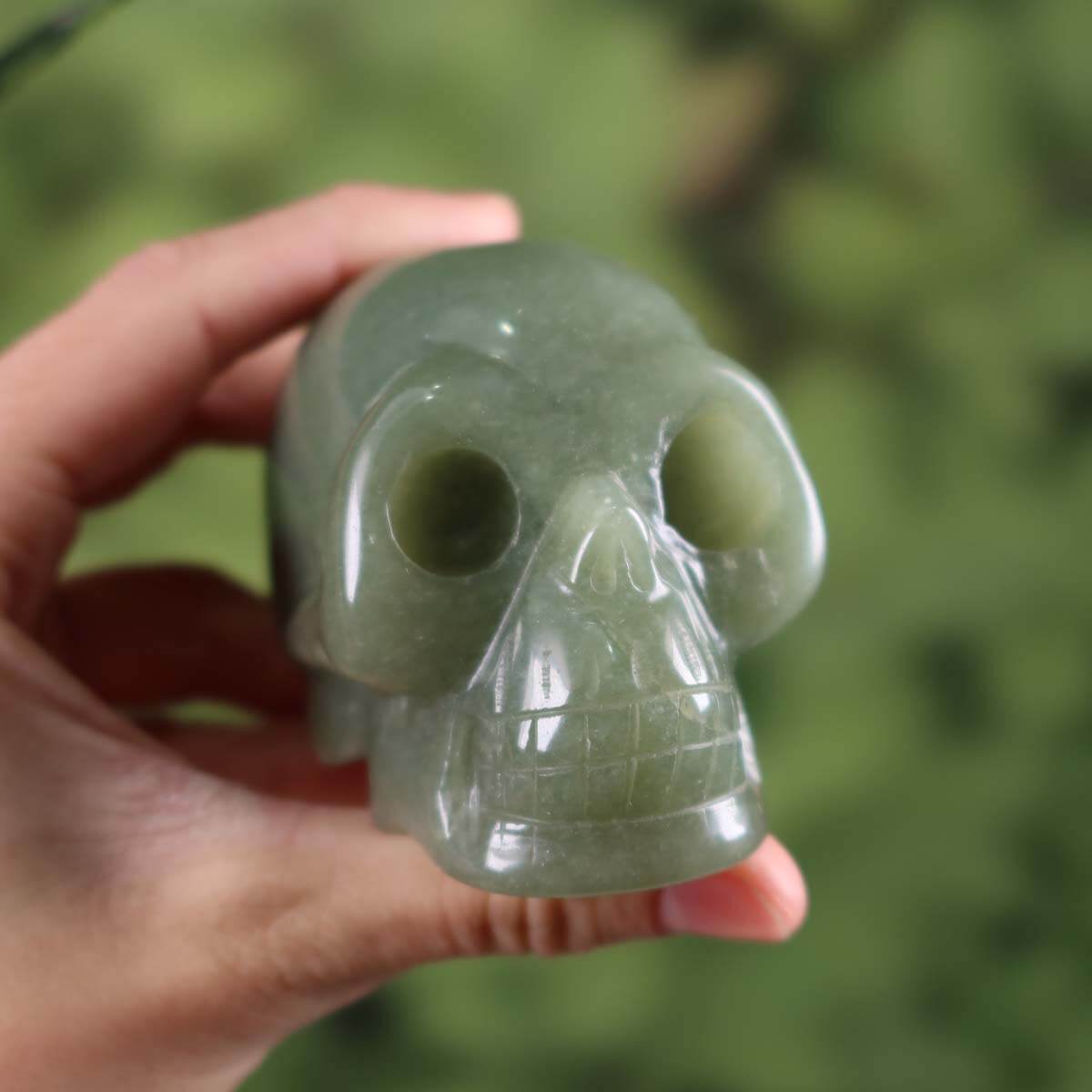 Handcrafted green aventurine crystal skull, unique mineral stone collectible, 7x5 cm, held in hand.