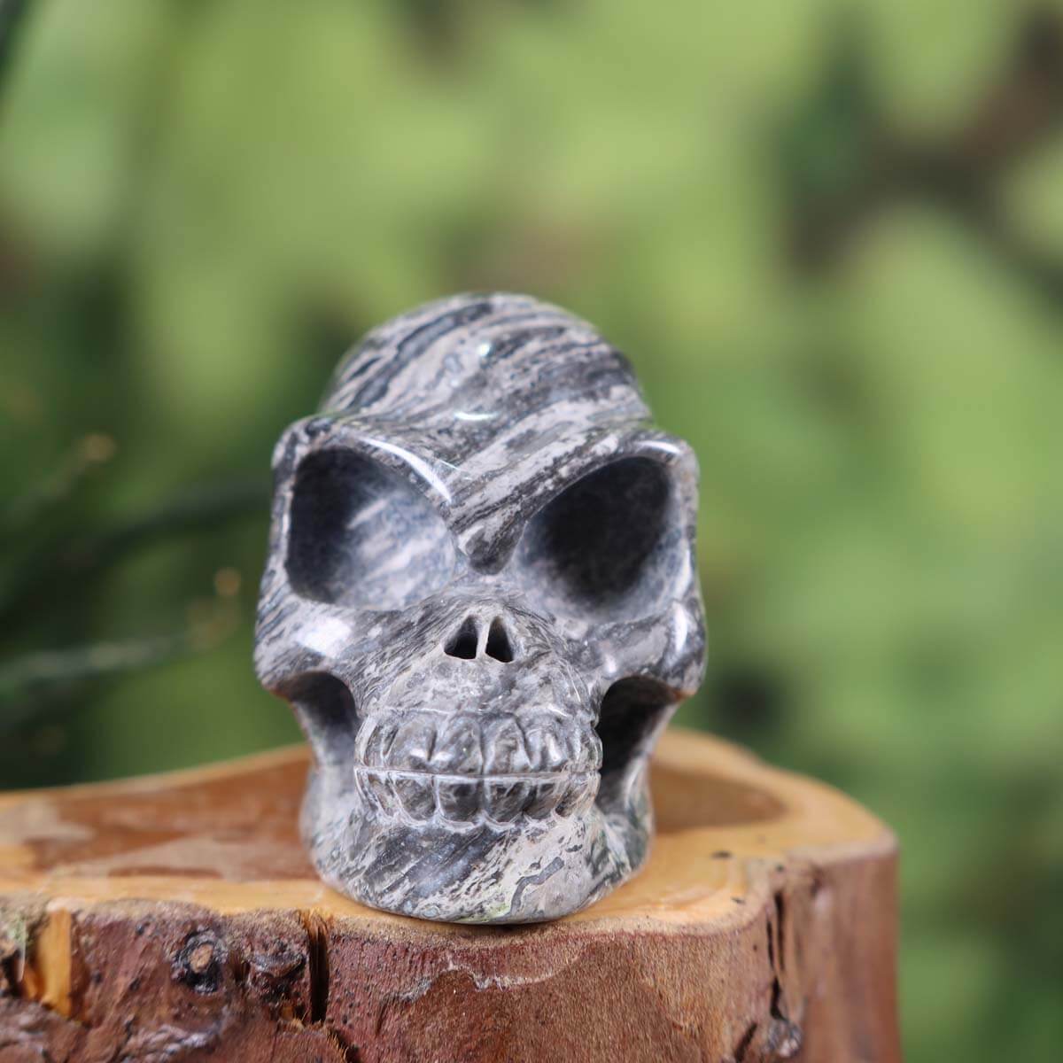 Handcrafted natural stone crystal skull with unique patterns, collector's item, available at Steinwelten online shop.