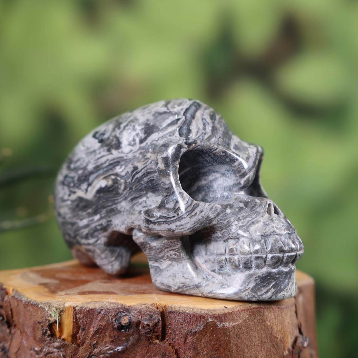 Handcrafted natural stone crystal skull with unique patterns, collector's item, available at Steinwelten online shop.