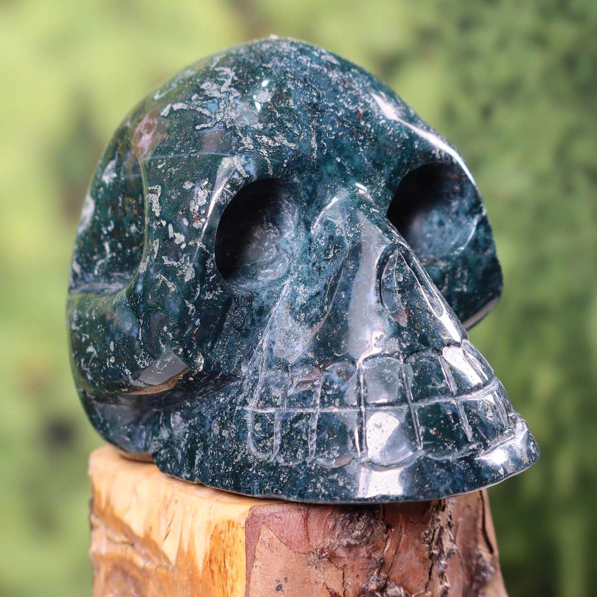 Handcrafted moss agate crystal skull, unique collectible piece, 13x10 cm. Buy minerals and gemstones online at Steinwelten.