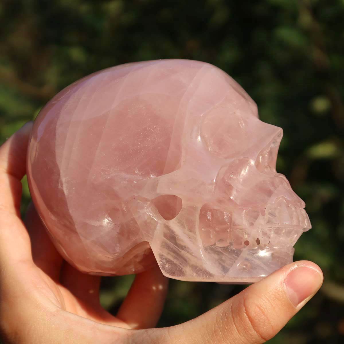 Handcrafted rose quartz crystal skull, unique collector's piece in 10x8 cm size, ideal for crystal skull collectors.