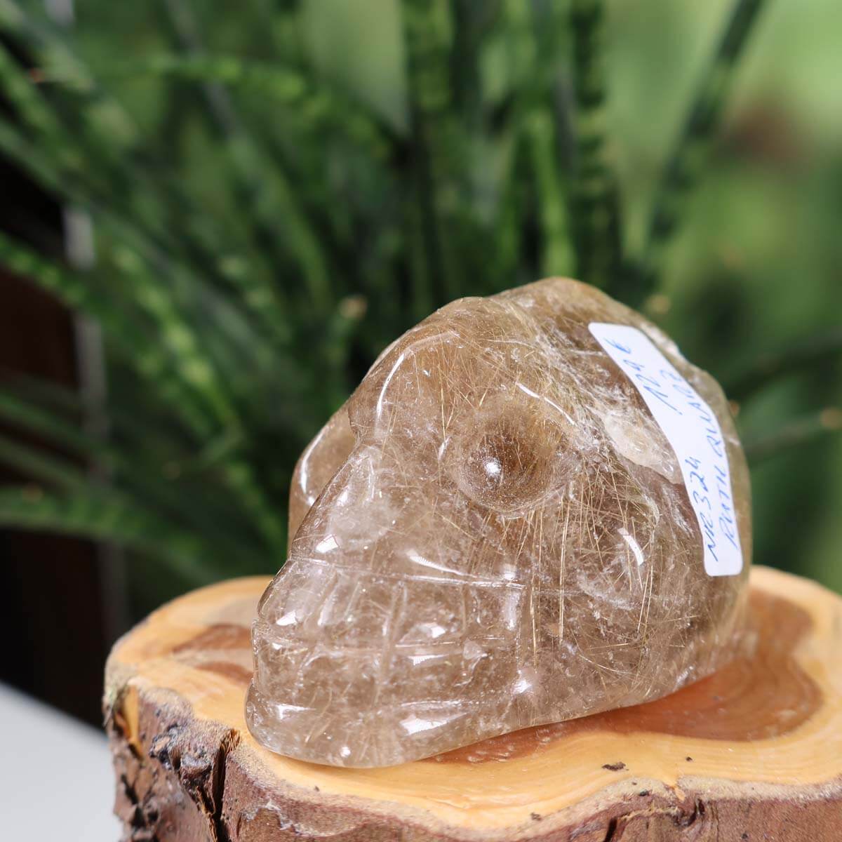 Handcrafted Rutil Quartz Crystal Skull, unique gemstone collectible, 6x5 cm, inspired by mineral and gemstone worlds.