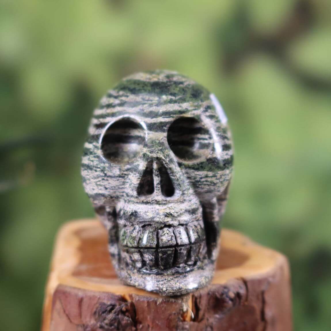Handcrafted Serpentin Silberauge crystal skull on wooden base, 7x7 cm, unique design and color, product number 365