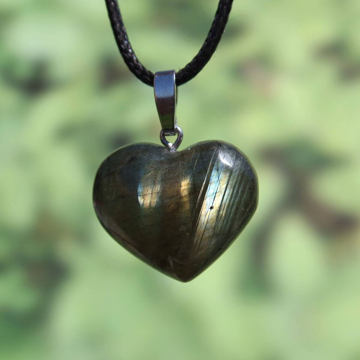 Heart-shaped Labradorite pendant 24mm displaying blue, green, and gold hues; handmade and unique for spiritual connection.