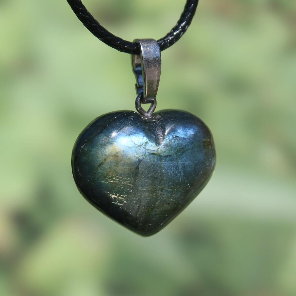 Heart-shaped labradorite pendant with blue and green hues, 22mm unique design, showcasing light reflection for intuition and spirituality.