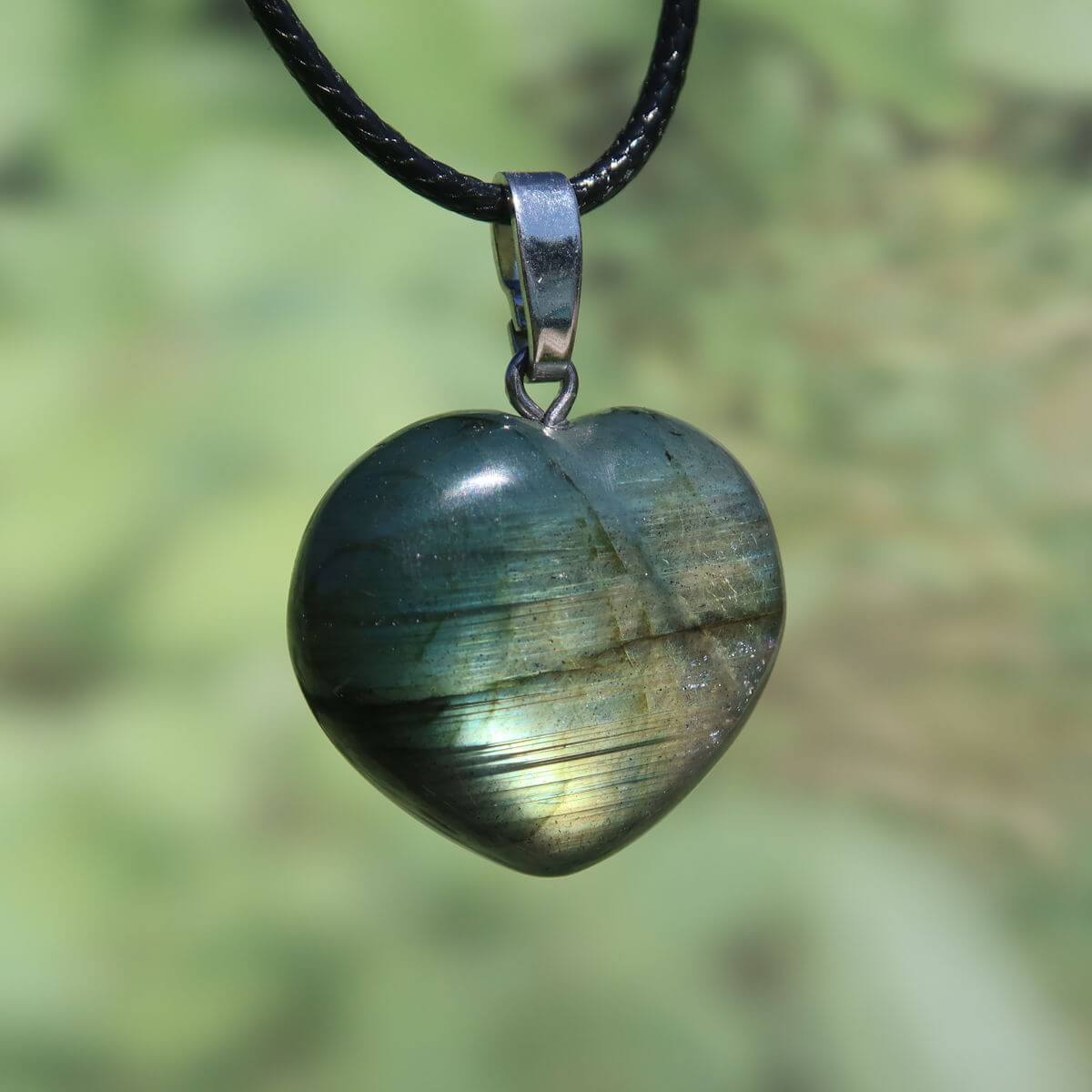 Heart-shaped labradorite pendant with iridescent blue and green hues, showcasing its unique and spiritual qualities.