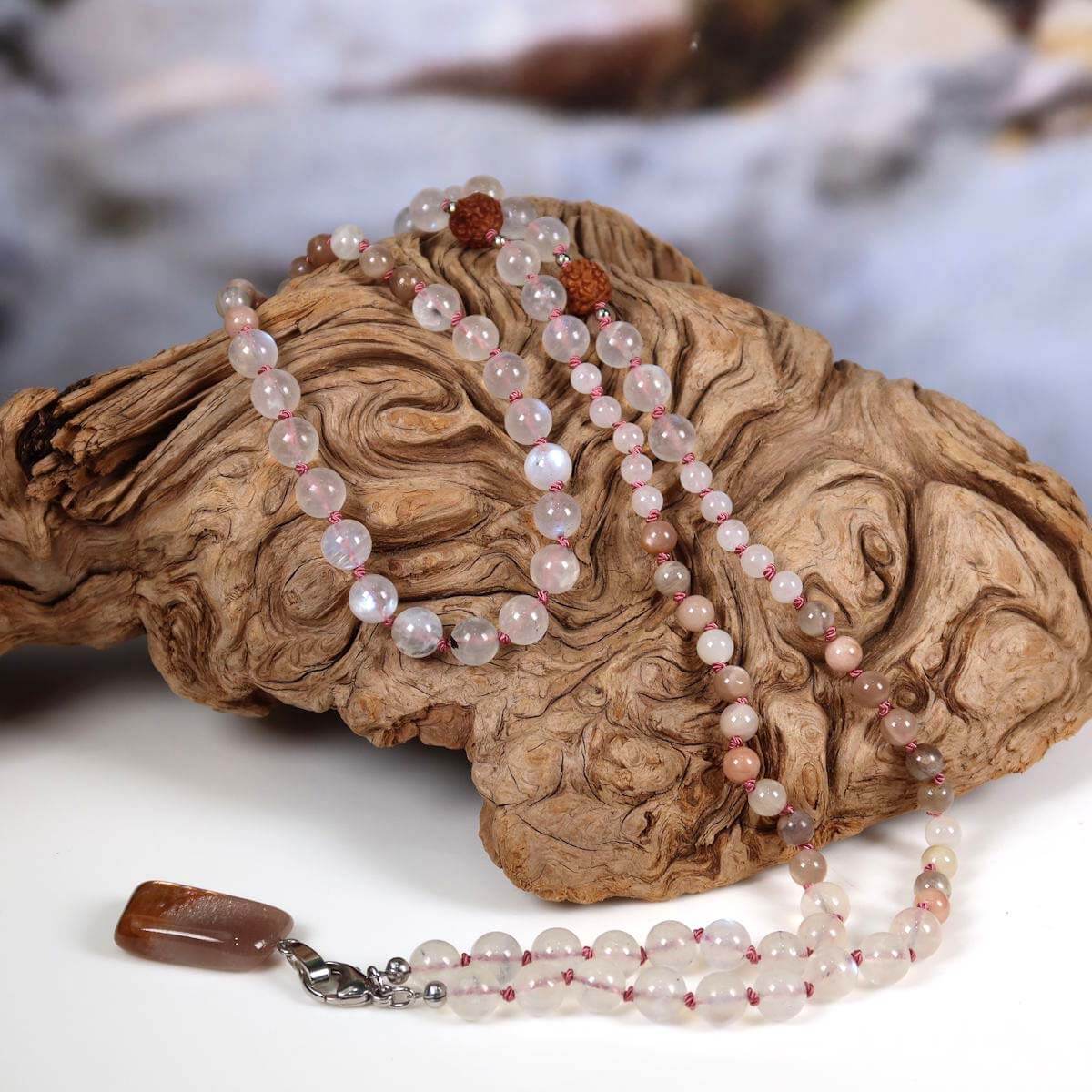 Mala necklace with white labradorite, moonstone, rudraksha beads, and a moonstone pendant, symbolizing intuition and femininity.