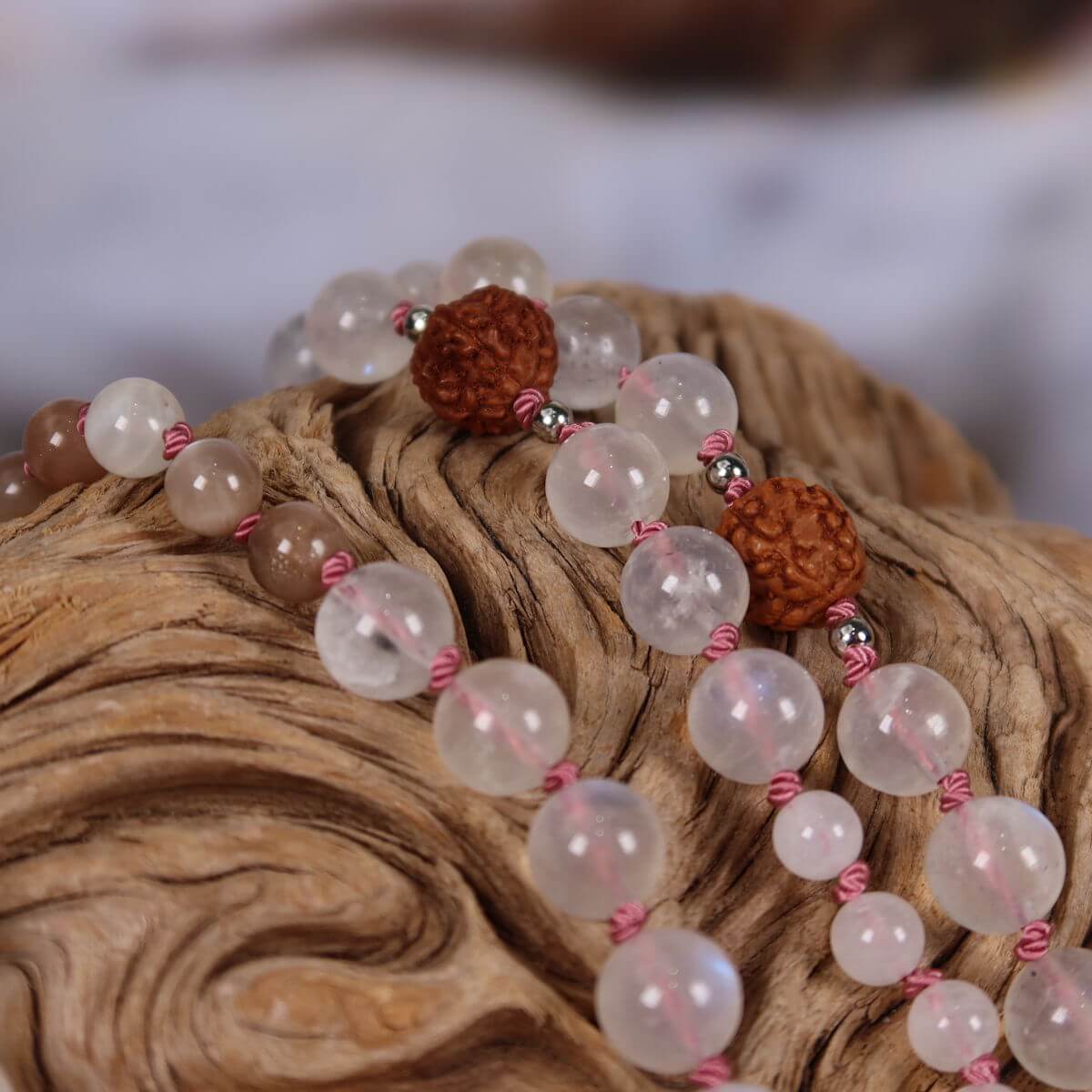 Mala necklace with white labradorite, moonstone, rudraksha beads, and a moonstone pendant, symbolizing intuition and femininity.