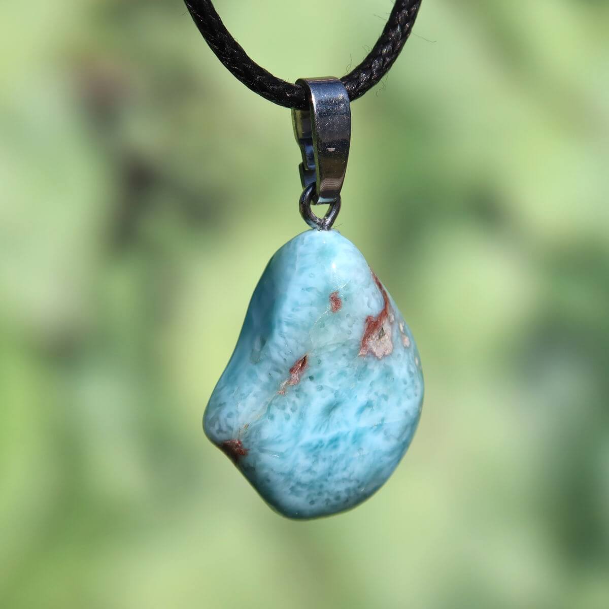 Larimar pendant with silver loop, 25mm, showcasing unique blue hues, crafted in Dominican Republic, enhances perception and protection.