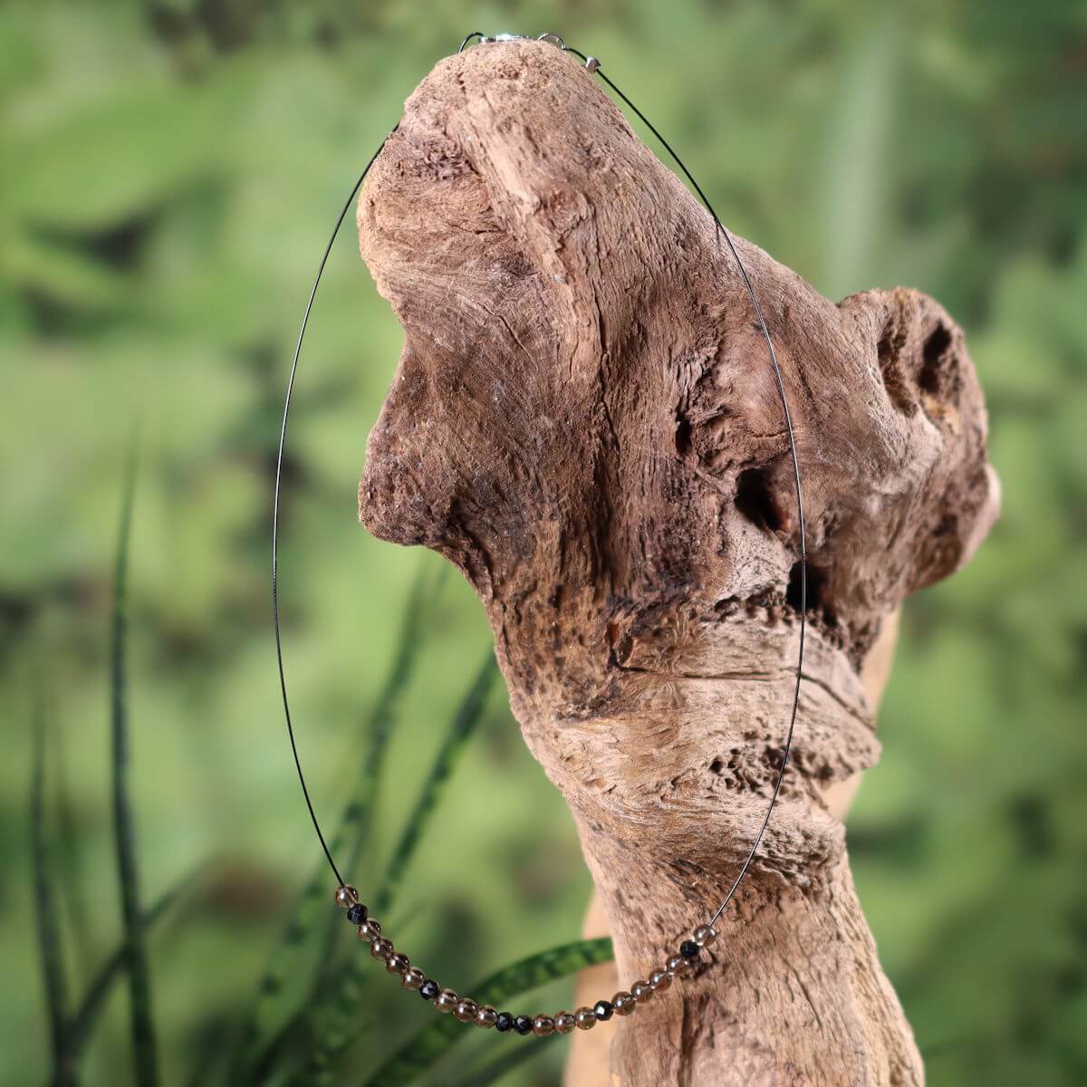 Handcrafted gemstone necklace with smoky quartz and spinel on wooden display, 40cm, for relaxation and focus.