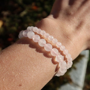 Rosenquarz facettiert Edelstein Armband - 1 Stück - in Varianten 4-6 oder 8mm auf einem Handgelenk im Sonnenlicht