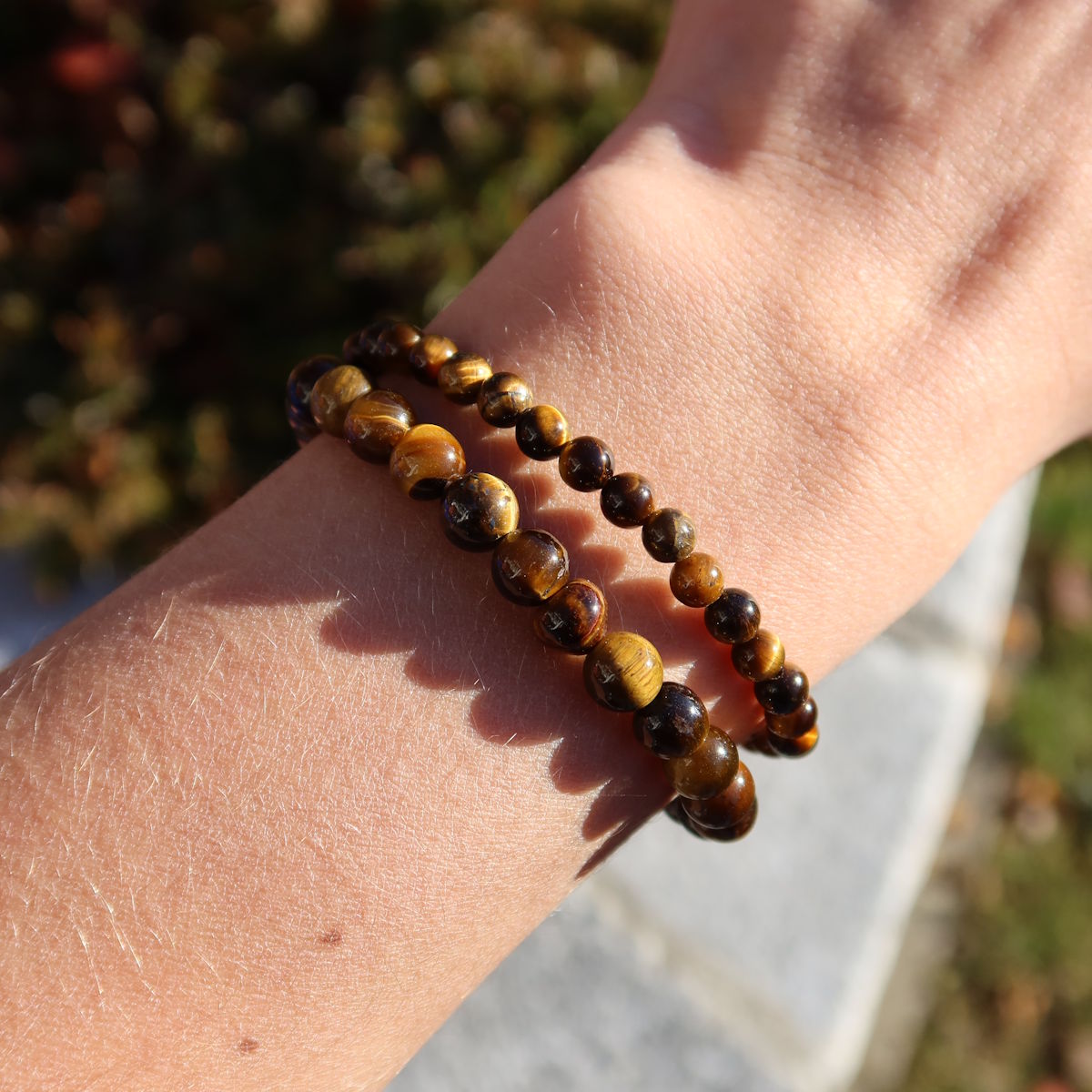 Tigerauge Edelstein Armband für schmale Handgelenke in Varianten 4-6 oder 8mm, auf Hand präsentiert.