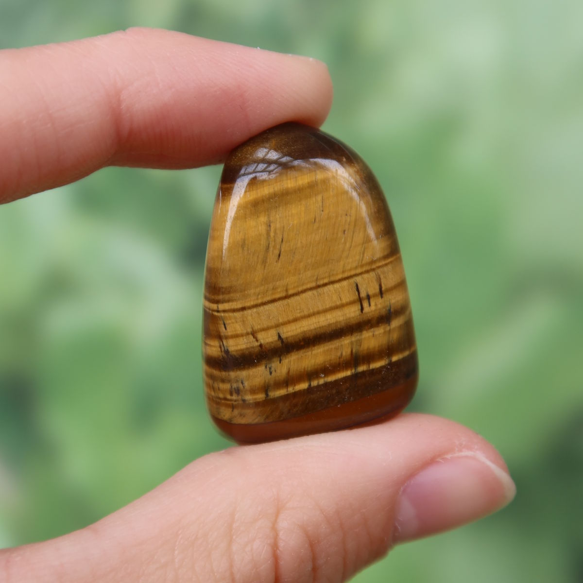 Tigerauge Handschmeichler 31mm - Selbstbewusstsein und Konzentration - Unikat Nr. 18 in Hand gehalten, glänzend und gestreift