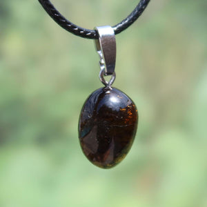 Turmalin Dravit Anhänger mit Silberschlaufe, tiefbrauner Edelstein auf Lederkette, einzigartiges Schmuckstück für Ruhe und Selbstsicherheit.