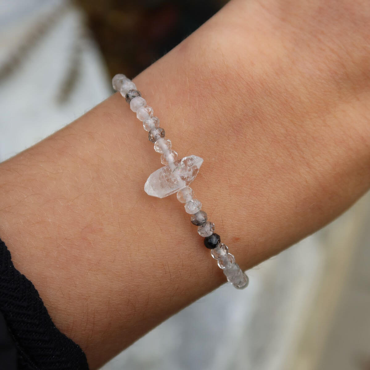 Hand wearing Turmalinquarz and Herkimer diamond faceted gemstone bracelet, 17cm handmade jewelry, showcasing style and elegance.