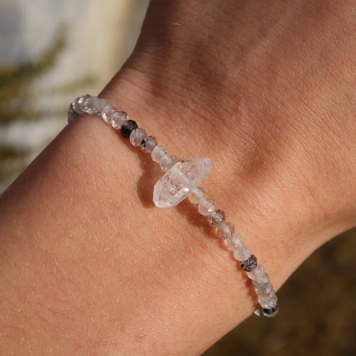 Hand wearing Turmalinquarz and Herkimer diamond faceted gemstone bracelet, 17cm handmade jewelry, showcasing style and elegance.