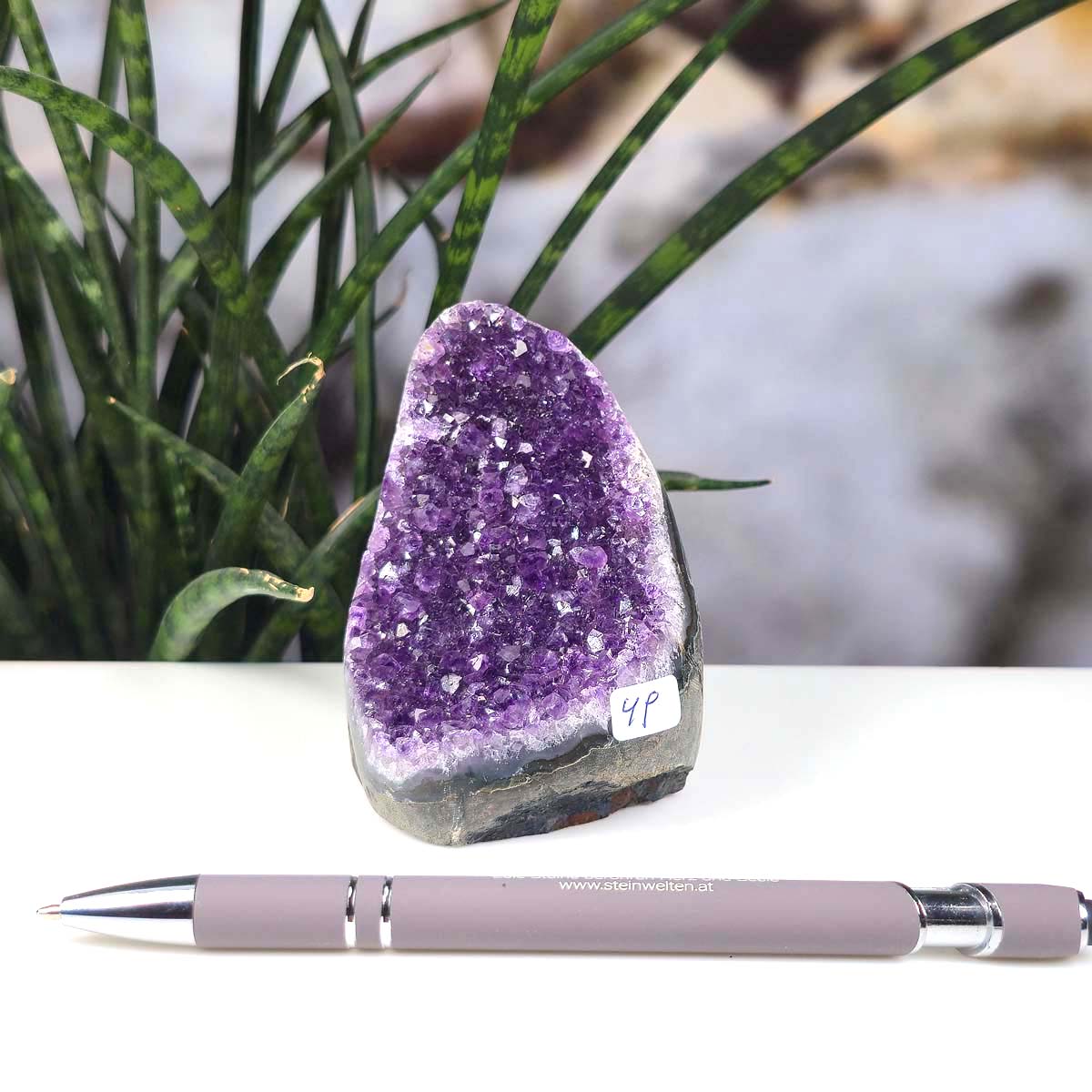Uruguay Amethyst Mini Geode - 9x6x7cm - Harmonie und Entspannung – extra dunkler Qualität - NR 49 next to a pen on a desk.