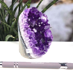 Uruguay Amethyst Mini Geode - 9x7x5cm - Harmonie und Entspannung – extra dunkler Qualität - NR 50 displayed on a table with pen