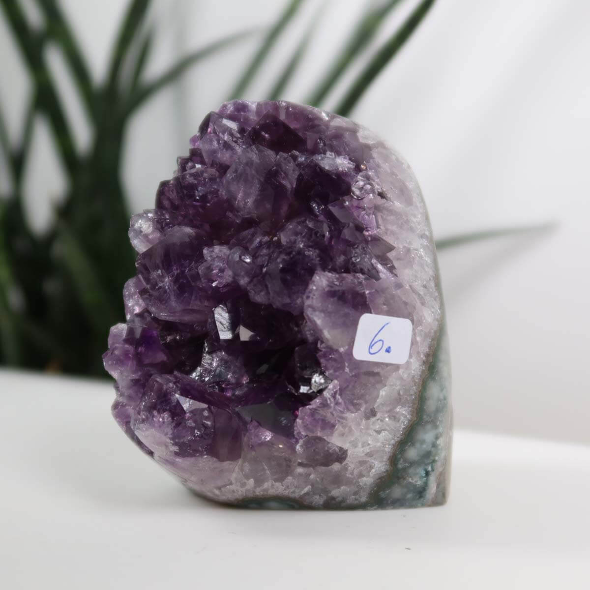 Uruguay Amethyst mini geode with dark purple crystals, measuring 5x8 cm, showcasing natural luster and intense color.