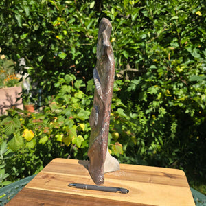 Dekorative handgefertigte Steinskulptur mit Ammoniten und Orthoceren (Fossilien) – 40x10x8cm - Nr. 74 auf einem Holztisch.