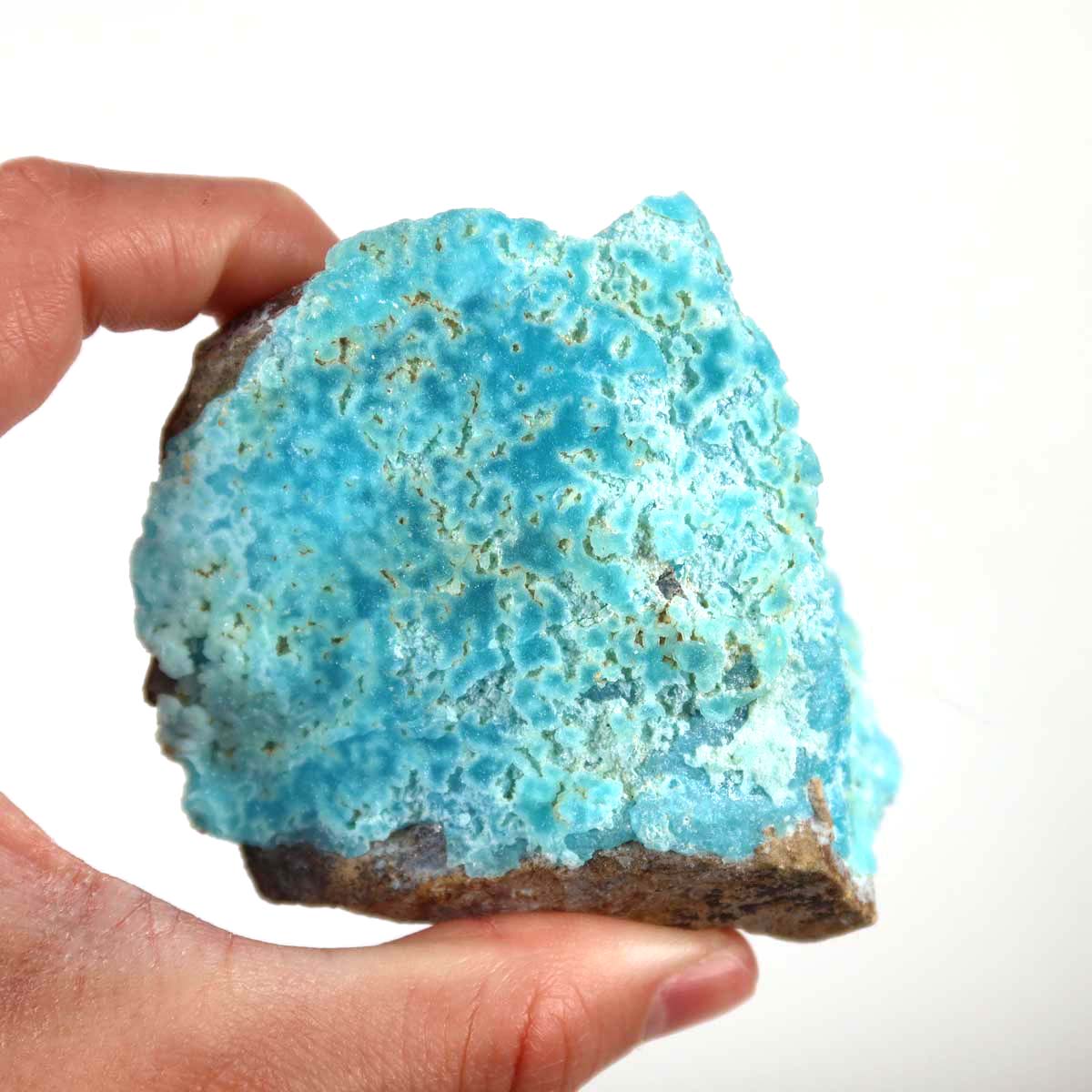Hand holding a turquoise blue Hemimorphite raw stone, showcasing natural colors and unique crystal structure, perfect for collectors.
