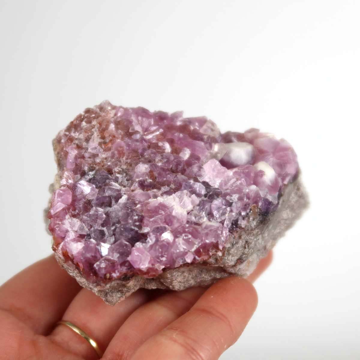 Natural Kobalt Calcit raw stone in hand displaying vibrant pink crystals, ideal for collectors. Unique Moroccan mineral specimen.