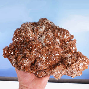 Hand holding natural raw Aragonite crystal cluster from Morocco, 23x20x10 cm, perfect for mineral collectors - Steinwelten Graz, Wiener Neustadt.
