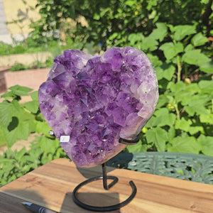 Amethyst Druse Amethyst Geode in Herzform mit Metallsockel 21x19x11cm - NR-8, glänzende lila Kristalle auf einem Metallständer.